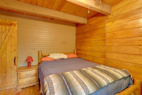 a bedroom with a bed in a log cabin at Secluded Mountain Cabin with Decks and Gazebo! in Brasstown
