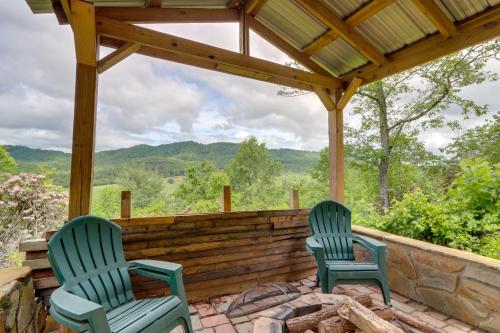 two chairs sitting on a patio with a pergola at Secluded Mountain Cabin with Decks and Gazebo! in Brasstown