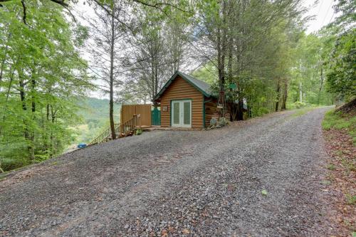 a house on the side of a dirt road at Secluded Mountain Cabin with Decks and Gazebo! in Brasstown