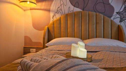 a bed with two candles on top of it at ARENA Sunset, Sea Coloseum View, 2 Rooms free Parking in Pula