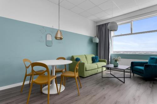 a living room with a couch and a table and chairs at Icelandic Apartments by Heimaleiga in Reykjavík