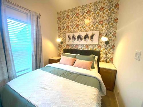 a bedroom with a bed and a floral wall at SLO Oasis Home in San Luis Obispo