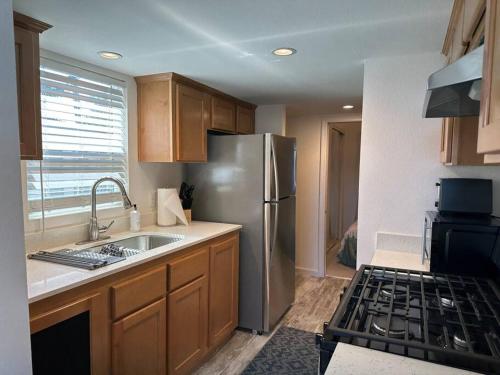 a kitchen with a stainless steel refrigerator and a stove at Oasis Home with Loft and Private Sauna in San Luis Obispo