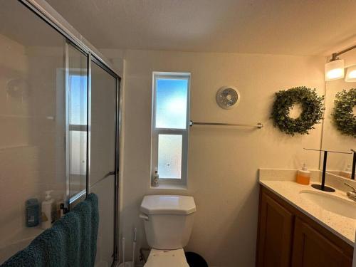 a bathroom with a toilet and a shower and a sink at SLO Oasis Home in San Luis Obispo
