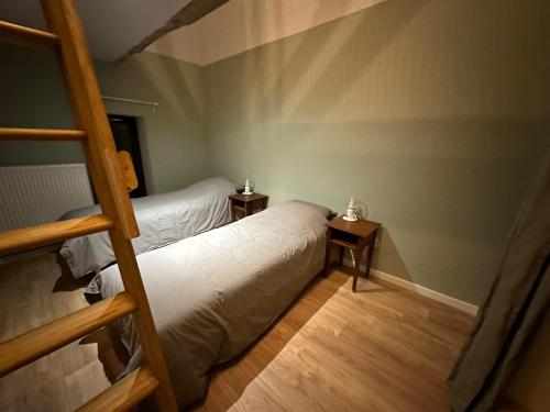 a bedroom with two bunk beds and a ladder at Gite confortable au milieu des prés - La ferme de Montigny in Neauphe-sur-Dives