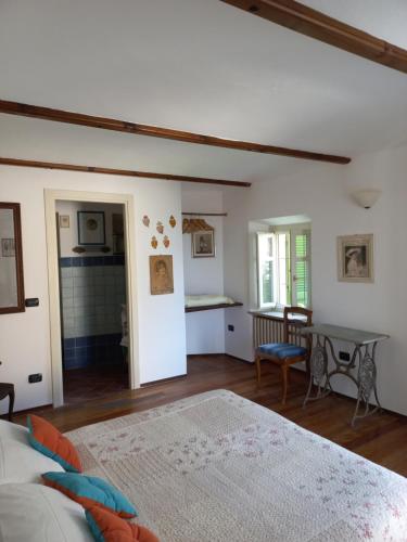 a bedroom with two beds and a table in it at Il giardino di Olivia in Guarene