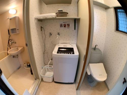 a small bathroom with a sink and a toilet at Big stone tsukuda - Vacation STAY 14554 in Aomori