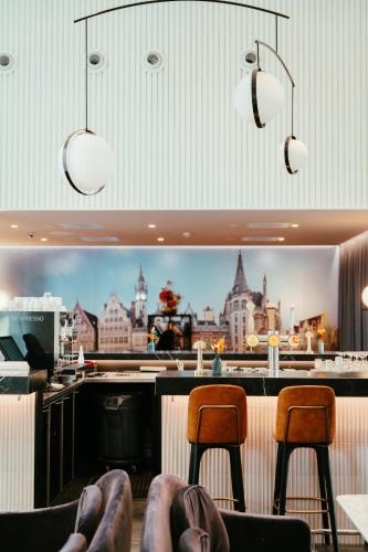 a bar with two chairs and a view of the city at Residence Inn by Marriott Ghent in Ghent