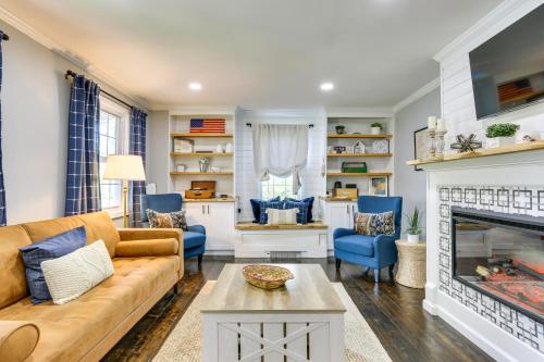 a living room with a couch and a fireplace at Bright Cornwall-On-Hudson Vacation Rental! in Cornwall-on-Hudson