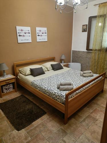 a bedroom with a large bed with two pillows on it at casa Maria in Palermo