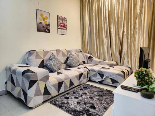 a living room with a couch in front of a window at 1 Dream Home @ Canopy Hills 2房1厕完美与齐全设备10分钟到达 UKM in Kajang