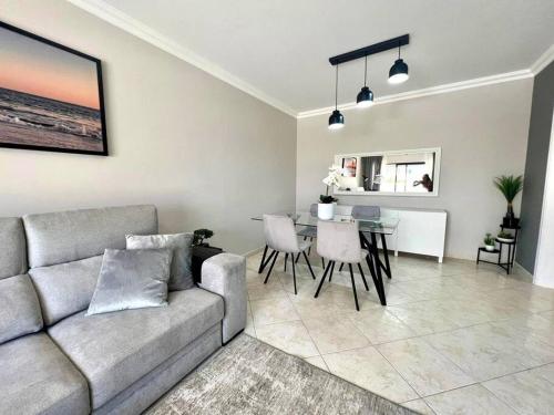 a living room with a couch and a table at Luxury Modern Beach Apartment in Quarteira