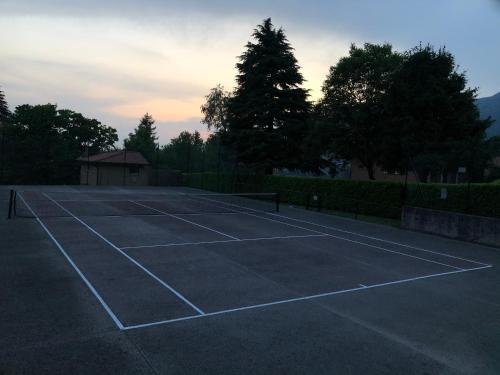 a tennis court with a net on it at MiniLOFT con Piscina Lago di Como Lecco in Galbiate
