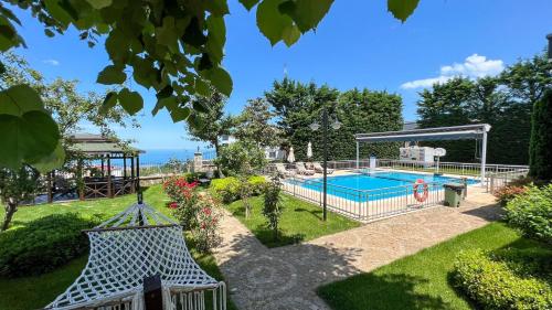 a pool in a garden with a gazebo at Heaven White Palace in Bostancı