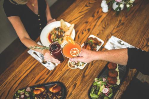 two people sitting at a table with food and drinks at Outlook Inn on Orcas Island in Eastsound