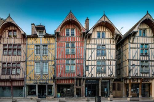 a row of old buildings in a street at Troyes City center rue zola : Space and Comfort in Troyes