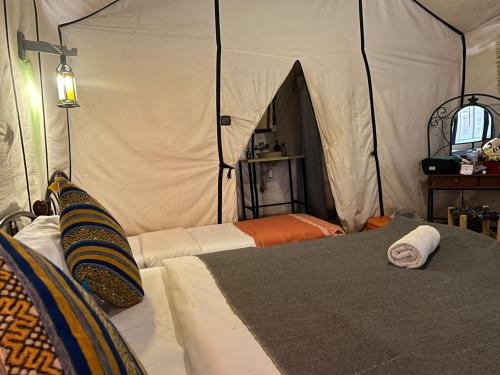 a bedroom with two beds in a tent at Desert Paradise Luxury Camp in Merzouga