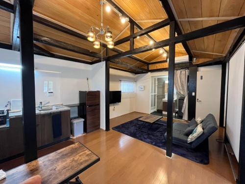 a living room with a couch and a kitchen at Whole house rental Mi-Casa Amami Craft - Vacation STAY 32735v in Amami