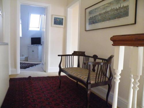 a living room with a chair and a fireplace at Broadlands Gate in Brockenhurst