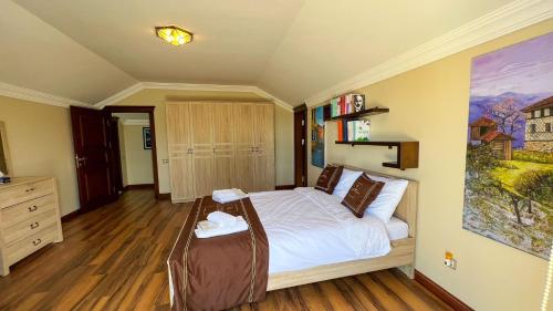 a bedroom with a large bed with a wooden floor at Heaven White Palace in Bostancı