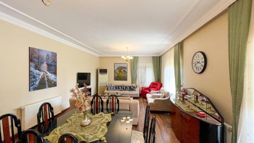 a living room with a table and a couch at Heaven White Palace in Bostancı
