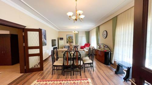 a dining room and living room with a table and chairs at Heaven White Palace in Bostancı