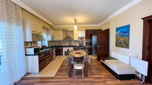 a kitchen with a table and a dining room at Heaven White Palace in Bostancı
