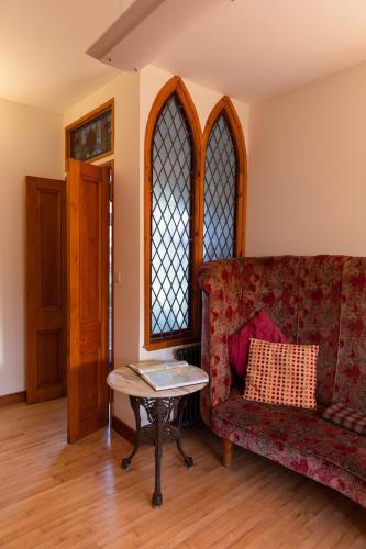 a living room with a couch and a table at Schoolhouse in Ballater