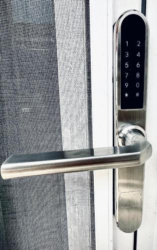 a close up of a glass door with a remote control at Aria Maison in Porto Heli