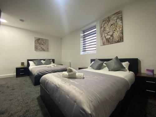 a hotel room with two beds and a window at Hotel Royal Blackburn in Blackburn