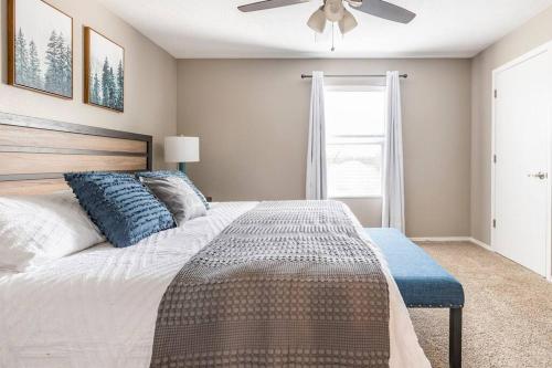 a bedroom with a large bed with a ceiling fan at 3BR Branson Condo PrimeLocation! in Branson