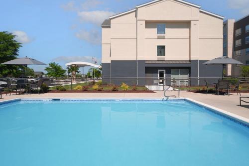 a large swimming pool in front of a building at Fairfield Inn & Suites by Marriott Jacksonville in Jacksonville