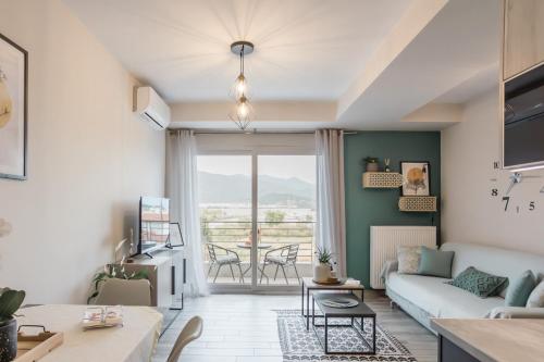 a living room with a couch and a table at Casa Karma in Volos