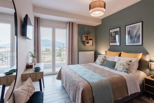 a bedroom with a bed and a large window at Casa Karma in Volos