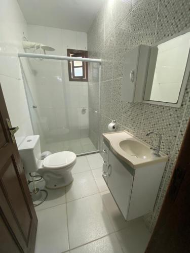 a bathroom with a toilet and a sink and a shower at Casa em Santa Teresa-ES in Santa Teresa