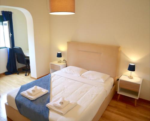 a bedroom with a bed with two towels on it at MCR Barreiro - O Limoeiro in Lavradio