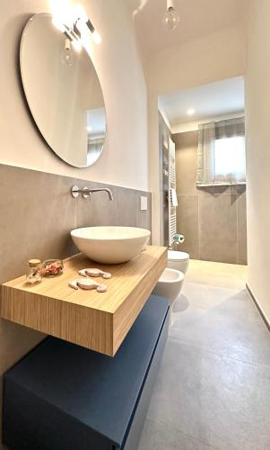 a bathroom with a sink and a mirror at Casa Clementina in Pisa