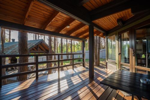 an empty porch of a house with a bench at Dacha 9 in Voropayev