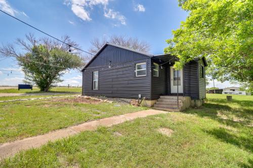 a small black house in a grassy field at Starlite Ranch 2 Acres with Views about 18 Mi to Waco in Lorena