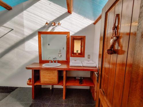 a bathroom with a sink and a mirror at Ecolodge K'arasirca in Comunidad Yumani