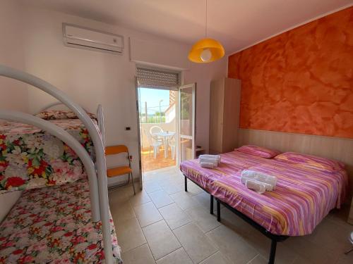 a bedroom with a bed and a balcony at Lu Jentu in Torre Ovo
