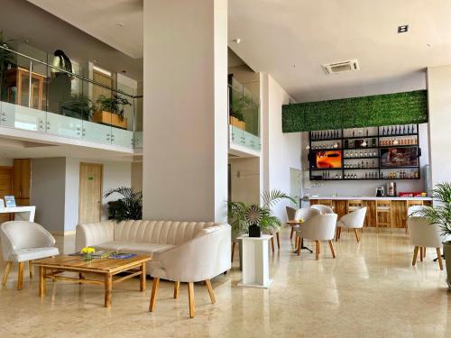 a living room with a couch and tables and chairs at Wyndham Garden Cartagena in Cartagena de Indias