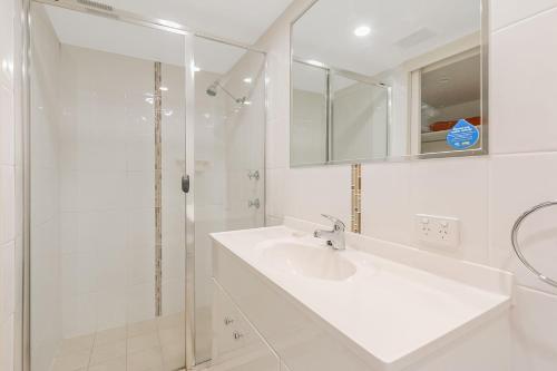 a white bathroom with a sink and a shower at Kooringal Unit 10 in Gold Coast