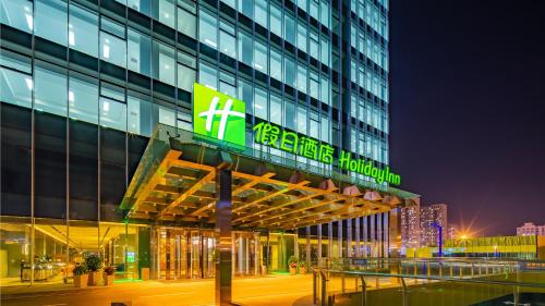 a building with a sign on the side of it at Holiday Inn Changchun Oriental Plaza by IHG in Changchun