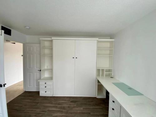 uma cozinha branca com armários brancos e uma secretária em Ocean View Newport Beach GEM! Ideal Longer Stays em Newport Beach