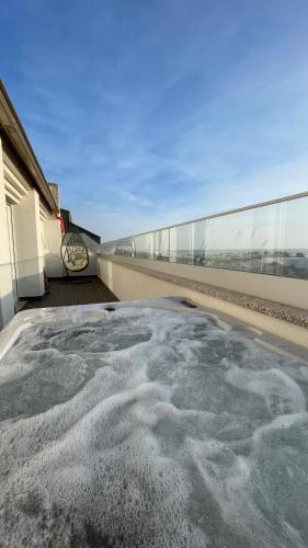 a hot tub on the side of a building at Casa Alegria Barra Deluxe by Home Sweet Home Aveiro in Praia da Barra