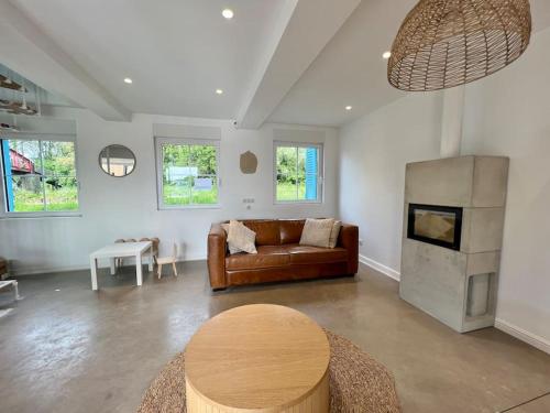 a living room with a couch and a fireplace at Les volets bleus in Saint-Venant