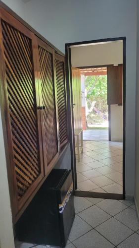 a room with a door open to a kitchen at Pousada Estalagem Vila Tania in Itaúnas