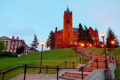 a large red building with a clock tower at Holiday Inn Express & Suites Dewitt - Syracuse by IHG in East Syracuse