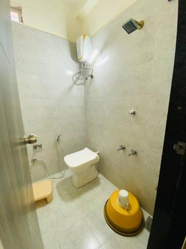 a bathroom with a toilet and a shower at SARDAR HOME STAY in Garudeshwar